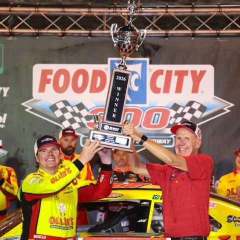 Sheldon Creed (left) and Food City CEO Steve Smith lift the Food City 300 trophy in celebration in Bristol Motor Speedway victory lane Friday night in Tennessee.