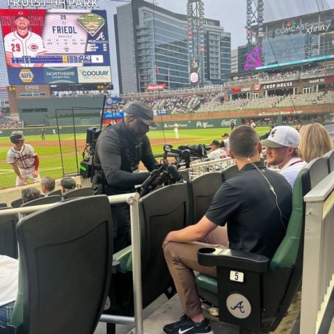 Ty Dillon is interviewed in his seat at the top of the third inning during the Braves-Reds game by Fan Duel Sports reporter Wiley Ballard.