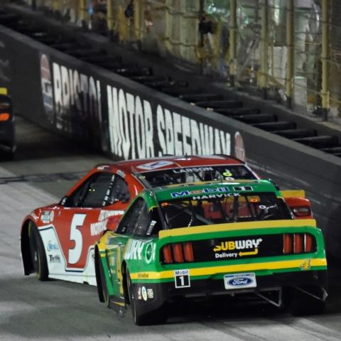 Kevin Harvick gives Kyle Larson a nudge as the two are battling for the lead in the closing laps of Saturday night's Bass Pro Shops NRA Night Race. Larson held on for the victory, his sixth of the season and first ever Cup win at Thunder Valley.