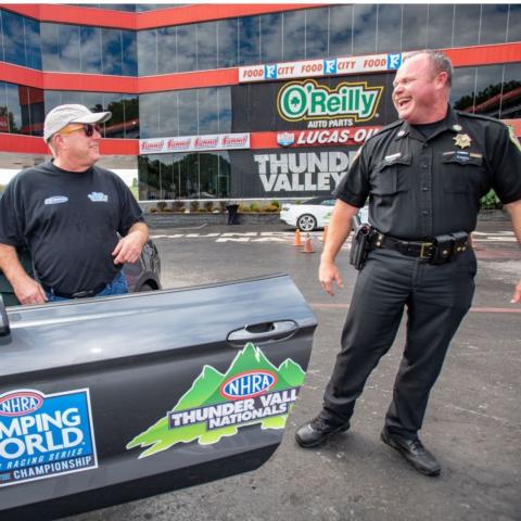 NASCAR crew chief Chris Carrier (left) and Sullivan County Sheriff Jeff Cassidy share a laugh during the NHRA Thunder Valley Nationals Celebrity Drag Race Challenge Wednesday at Bristol Dragway. 