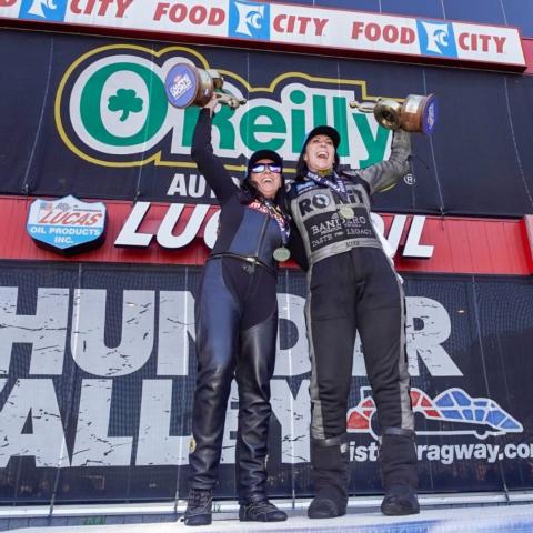 Angelle Sampey (left) and Alexis DeJoria shared the winner's circle stage Sunday after scoring victories in the NHRA Thunder Valley Nationals at historic Bristol Dragway.