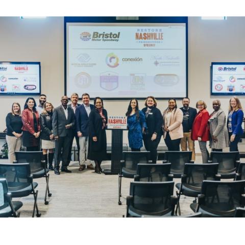 BMS executive vice president and general manager Jerry Caldwell, center, second from left at podium, welcomed representatives from six community benefits partners today during a special luncheon in Nashville as part of the revitalization plan for the historic Fairgrounds Speedway.