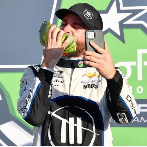 Ross Chastain enjoys a chunk of watermelon during his victory lane celebration Sunday at COTA where he earned his first NASCAR Cup Series win.