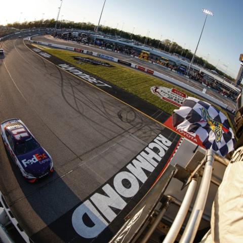Denny Hamlin takes the checkered flag to win Sunday's NASCAR Cup Series race at Richmond Raceway in Virginia.