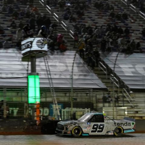 Ben Rhodes takes the checkered flag Saturday night during the Pinty's Truck Race on Dirt at Bristol Motor Speedway.
