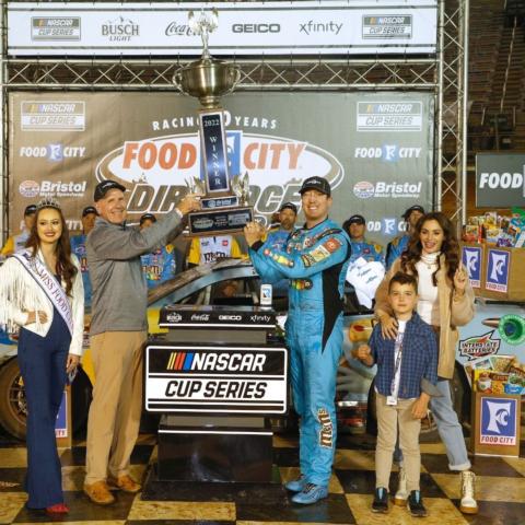 Kyle Busch raises the huge Bristol Motor Speedway signature trophy with Food City President and CEO Steve Smith Sunday night after winning the Food City Dirt Race.