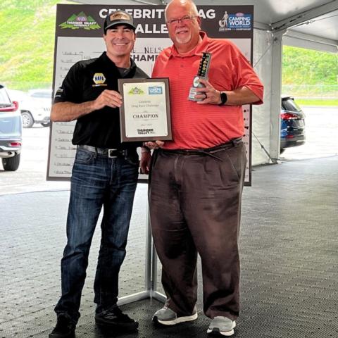 Veteran radio broadcaster Duane Nelson is presented his trophy and plaque for winning the Thunder Valley Celebrity Drag Challenge Tuesday at Bristol Dragway by NHRA Funny Car champ Ron Capps.