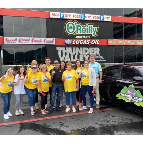 Birthplace of Country Music's Leah Ross (fourth from right) brought her own cheering section to the Thunder Valley Celebrity Drag Challenge. Leah and the crew took a few minutes to pose for a photo with NHRA driver Ron Capps (center) and Bristol Motor Speedway/Dragway President Jerry Caldwell (right). 