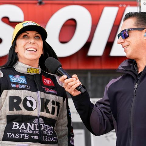 Alexis DeJoria is interviewed during pre-race ceremonies for the NHRA Thunder Valley Nationals last October by NHRA Announcer Joe Costello. 