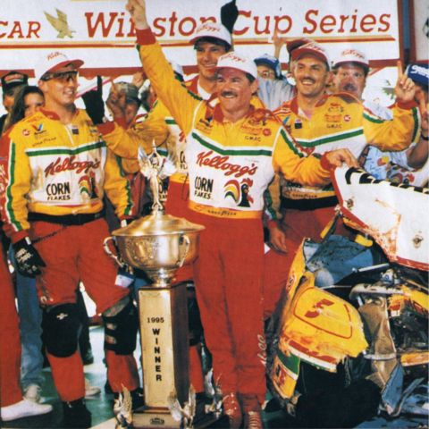 Terry Labonte posed proudly beside his crumpled Chevy after winning the 1995 Night Race and surviving a final-lap bump from Dale Earnhardt. His car was spewing steam and leaking fluids as it sat in Victory Lane. The finish was named the No. 1 wildest finish in BMS history.