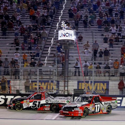 Kyle Busch (51) and Timothy Peters (17) careened across the finish line as the checkered flag waved in the 2013 UNOH 200.