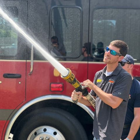 NASCAR Camping World Truck Series driver Grant Enfinger, who pilots the No. 23 Chevy for GMS Racing and one of the favorites in the Truck Series Playoffs, helped BMS officials make the Neighborhood Heroes presentation. Here, Enfinger blasts some water from the Northview/Kodak Fire Dept. truck as the crew gave him a tour of its capabilities. The Northview/Kodak Fire Dept is also one of the BMS Neighborhood Heroes recognized today.