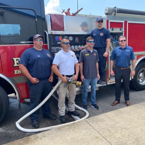 Northview/Kodak Fire Chief John Satterfield (white shirt) was joined by two members of his crew, NASCAR Camping World Truck Series star Grant Enfinger (center) and BMS President Jerry Caldwell (right) for a photo by one of their trucks during a press conference to name the unit one of the BMS Neighborhood Heroes for 2022.