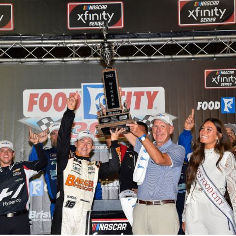 Food City CEO and President Steve Smith helps Food City 300 winner A.J. Allmendinger lift the trophy high in the air in a Victory Lane ceremony where the race winning car was too damaged to make it up on the BMS rooftop. 