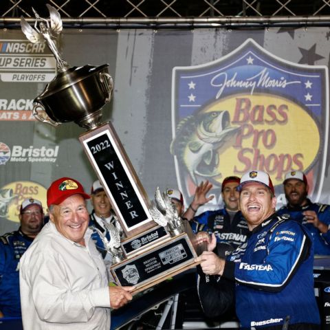 Bass Pro Shops owner Johnny Morris helps Saturday night's race winner Chris Buescher pick up the huge Bristol Motor Speedway trophy in Bristol's famed rooftop Victory Lane.