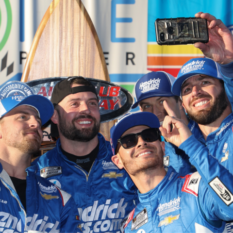 Kyle Larson celebrates by taking a selfie with team members in Victory Lane after winning the Cup Series race in Southern California on Sunday.