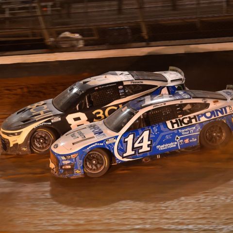 Chase Briscoe (14) tried to execute a "Slide Job" on then leader Tyler Reddick (8) coming out of Turn 4 on the final lap of the 2022 Food City Dirt Race at dirt-covered Bristol Motor Speedway. The move took both drivers out of contention and opened the door for Kyle Busch to streak by and take the checkered flag.