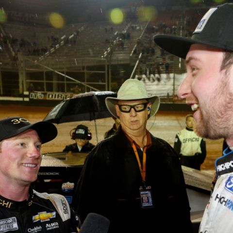 Following their final lap tangle in the 2022 Food City Dirt Race at dirt-covered Bristol Motor Speedway, Tyler Reddick (left) and Chase Briscoe (right), both with big smiles on their faces, politely discussed what took place on the track in the race's final lap to the surprise of BMS fans and the NASCAR security official, who was ready just in case things got physical.