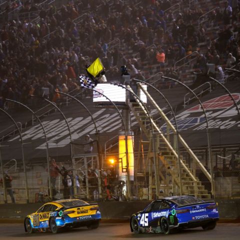 Christopher Bell sees the checkered flag wave Sunday night at the Food City Dirt Race which ended under caution. Tyler Reddick (45) was fast-approaching in the closing laps but ultimately finished second.