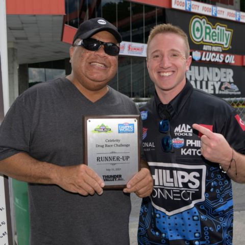 NHRA Top Fuel driver Justin Ashley (right) congratulates Thunder Valley Celebrity Drag Challenge runner-up Kenny Hawkins from WJHL Sports.