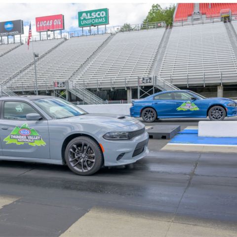 WCYB's Kristen Quon (left lane in blue) pulled away for the victory from WJHL's Kenny Hawkins (right lane in gray) in the final round of Wednesday's Thunder Valley Celebrity Drag Challenge at historic Bristol Dragway.
