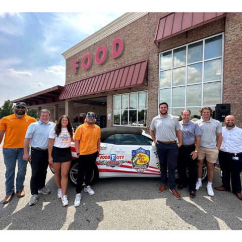 The participants in today's news conference for the BMS Neighborhood Heroes program in Knoxville gathered for a photo around the BMS Pace Car. From left to right: Austin Lewis, UT Football; Jerry Caldwell, BMS President; Camryn Sarvis, UT Softball; Kirby Connell, UT Baseball; Dane Davis, UT Football; Ron Tacker, Food City; Colby Backus, UT Baseball; Steven Jones, Food City.