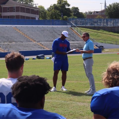 Bristol Motor Speedway President and General Manager Jerry Caldwell (right), presented Tennessee State head football coach Eddie George with a commemorative plaque for being selected as the BMS Neighborhood Hero for the Nashville region today during a presentation following the team's practice at historic Hale Field.