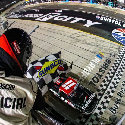 Corey Heim takes the checkered flag to win the UNOH 200 presented by Ohio Logistics Thursday night at Bristol Motor Speedway