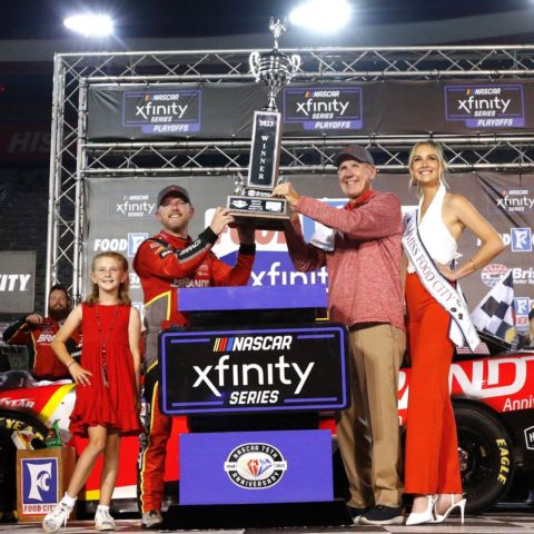 Food City 300 winner Justin Allgaier raises the trophy with Food City CEO Steve Smith and Miss Food City during the post-race celebration in Bristol Motor Speedway's elevated Victory Lane.