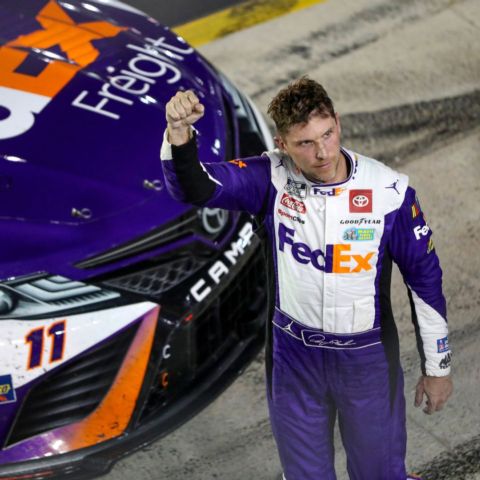 Denny Hamlin raised his fist in victory Saturday night after winning the Bass Pro Shops Night Race and advancing to the Round of 12 Playoffs in the NASCAR Cup Series.