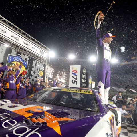 Denny Hamlin celebrates on top of his No. 11 race car Saturday night after winning the Bass Pro Shops Night Race and advancing to the Round of 12 Cup Series Playoffs. It was Hamlin's third Night Race victory at Bristol Motor Speedway.