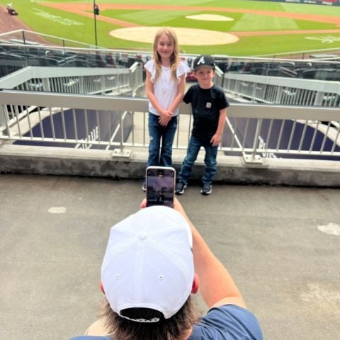 Ty Dillon takes a photo of his children, Oakley (left) and Kapton at the Braves-Reds game on May 7. Dillon was in town to help promote NASCAR and the upcoming MLB Speedway Classic at BMS.
