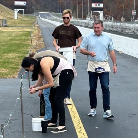 BMS President Jerry Caldwell (far right) hangs holiday lights alongside BMS employees to get the property ready for the annual Food City Speedway In Lights fundraiser for the Bristol chapter of Speedway Children's Charities, which raised more than $1 million last year for area children in need.